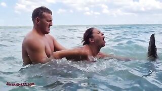 A couple enjoys romantic sex right in the middle of the sea