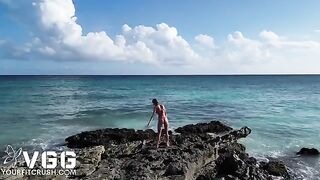 A hot girl is playing on the beach without any clothes