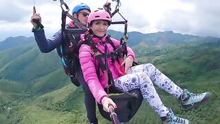 A girl squirts while paragliding 2200 m above the sea, in a daring act