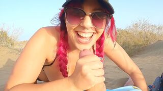 A girl is flashing her body on the beach while others pass by