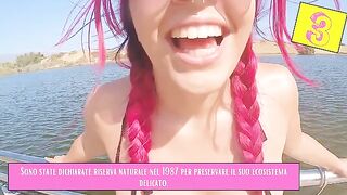 A girl is flashing her body on the beach while others pass by