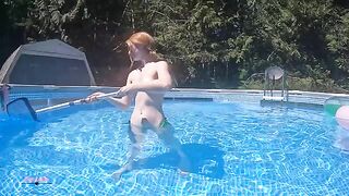 Redhead in red bikini diving in the pool - ignore