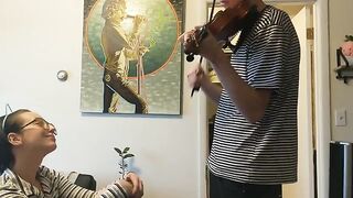 The couple was interrupted while the girl tried to play violin