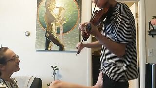 The couple was interrupted while the girl tried to play violin