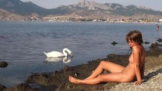 Nudist girl has sex on the riverbank with someone