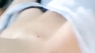 A half-naked girl is telling a lie and caressing her body with her hands