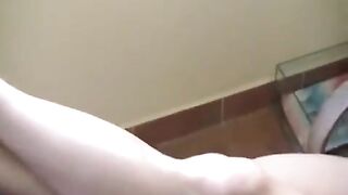 A naked girl with big natural tits is smoking in the room