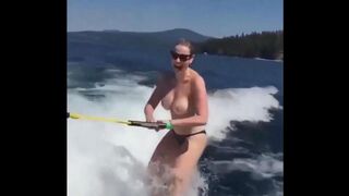 Girl skis on water with her tits out of clothes