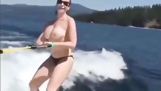 Girl skis on water with her tits out of clothes