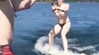 Girl skis on water with her tits out of clothes