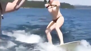 Girl skis on water with her tits out of clothes