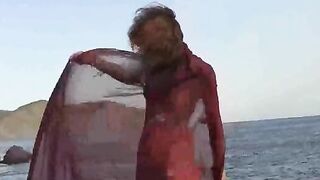 A small boobed nudist gets wet and horny in the rain
