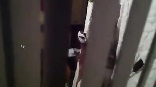 A man shoots a hidden camera as his neighbors have sex