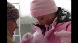 Two girls are having fun in the snow