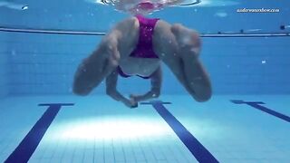 A naked woman is swimming in the pool, showcasing her body