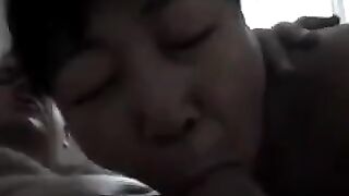 Chinese beauty practices her blowjob skills on an adult man