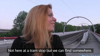 A blond girl is having fun with a guy in the bushes