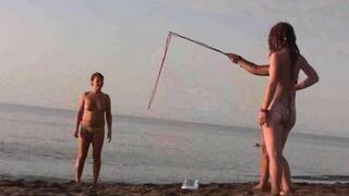 A couple has fun on the beach without any clothes