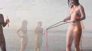A couple has fun on the beach without any clothes