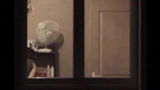 He admires himself naked in the mirror, completely bare