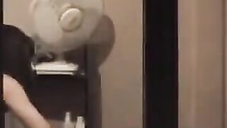He admires himself naked in the mirror, completely bare