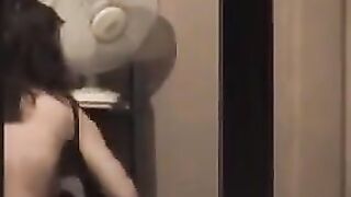 He admires himself naked in the mirror, completely bare
