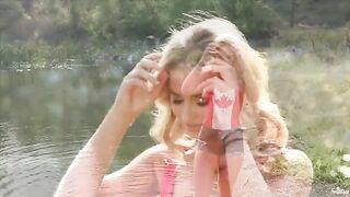 Blonde tenderness caresses herself on the lake shore