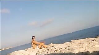 A very nice girl is basking in the sun completely naked