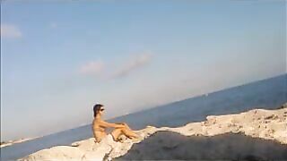 A very nice girl is basking in the sun completely naked