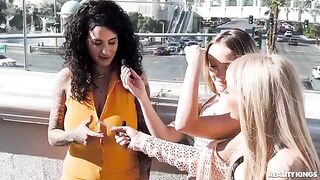 Two girls are having fun on the strip with each other