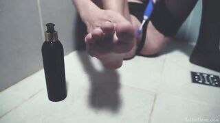 In the shower, girl plays with her pussy with a toy