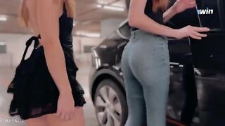 Two cute 18 y.o. girls are trying to hold their hood up, but it’s tough
