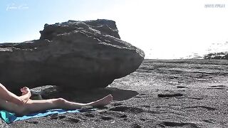 A girl removed her swimwear and caressed herself on the beach